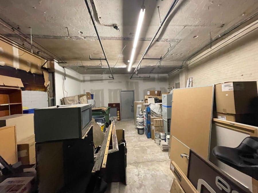 Underused basement space cluttered with furniture and boxes