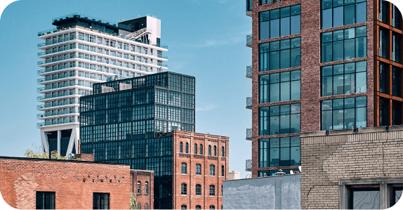 Brooklyn waterfront skyline mixing brick warehouse buildings with modern glass towers